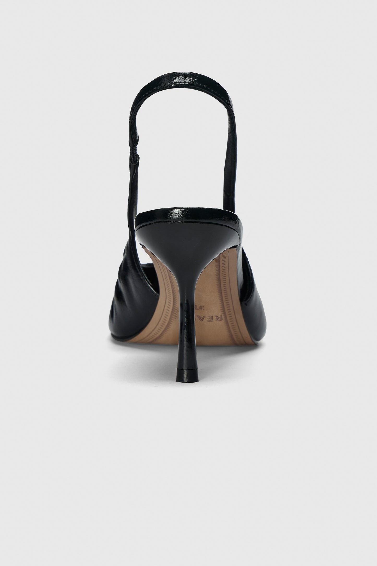 Black leather high heeled slingback shoes with pointed toe