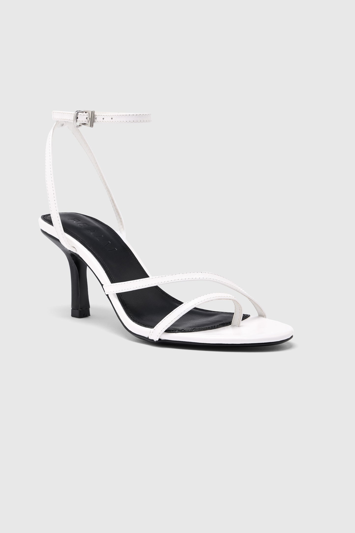 White leather asymmetric heeled sandals with an ankle strap