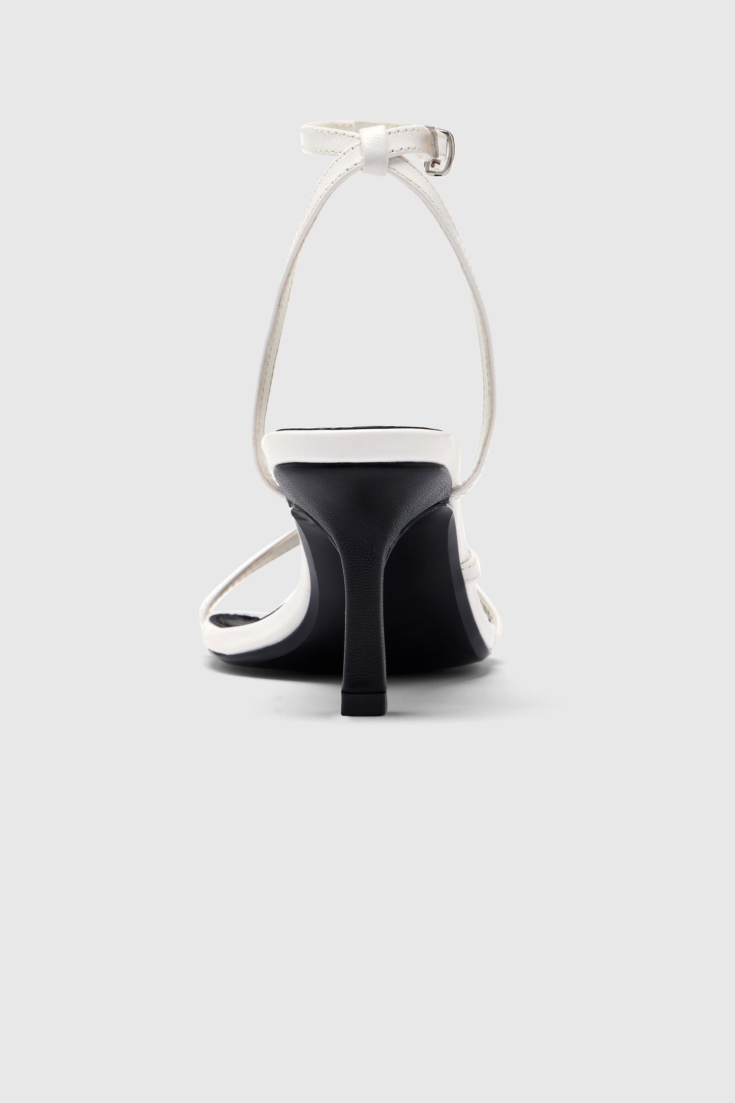 White leather asymmetric heeled sandals with an ankle strap