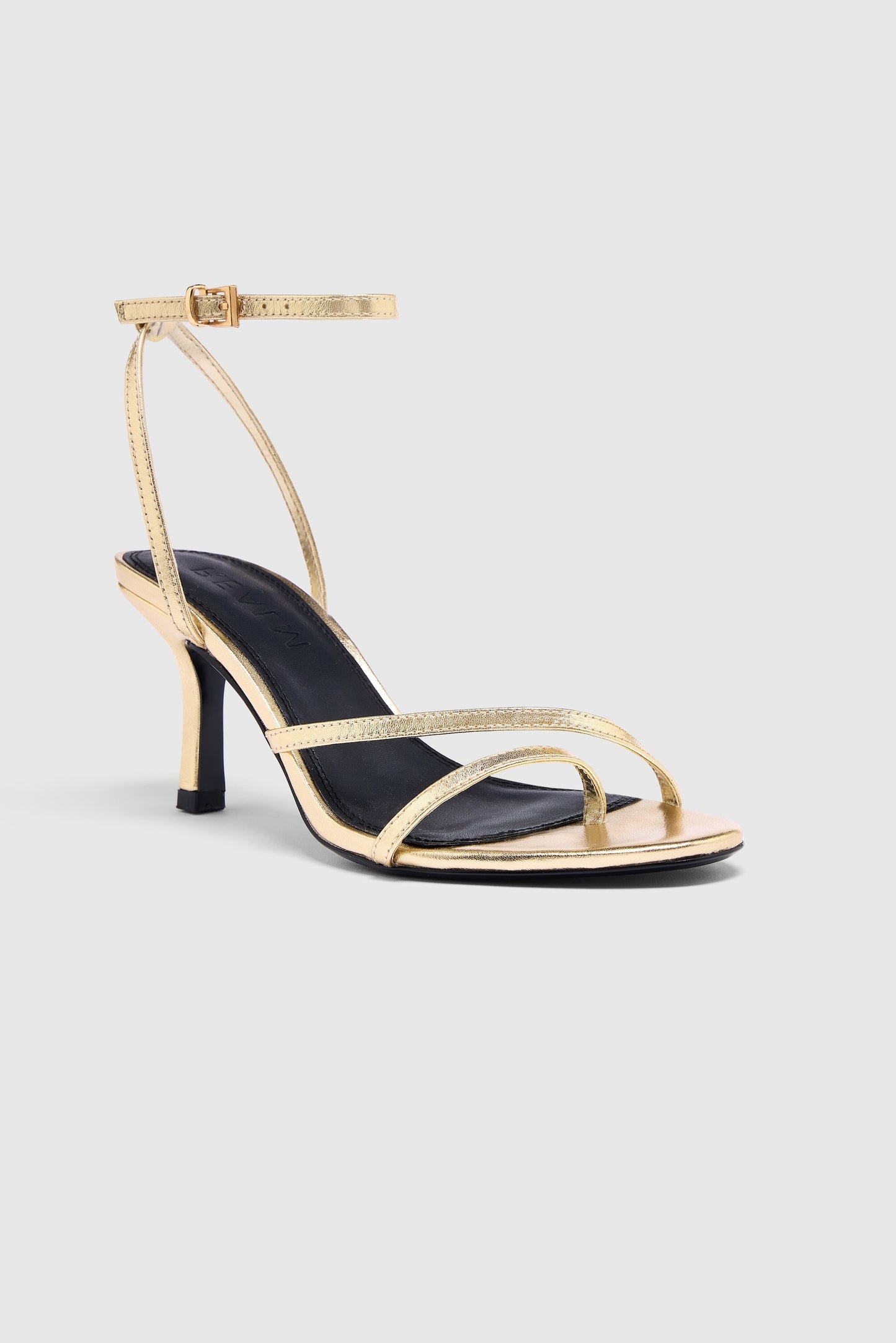 Gold leather asymmetric heeled sandals with an ankle strap