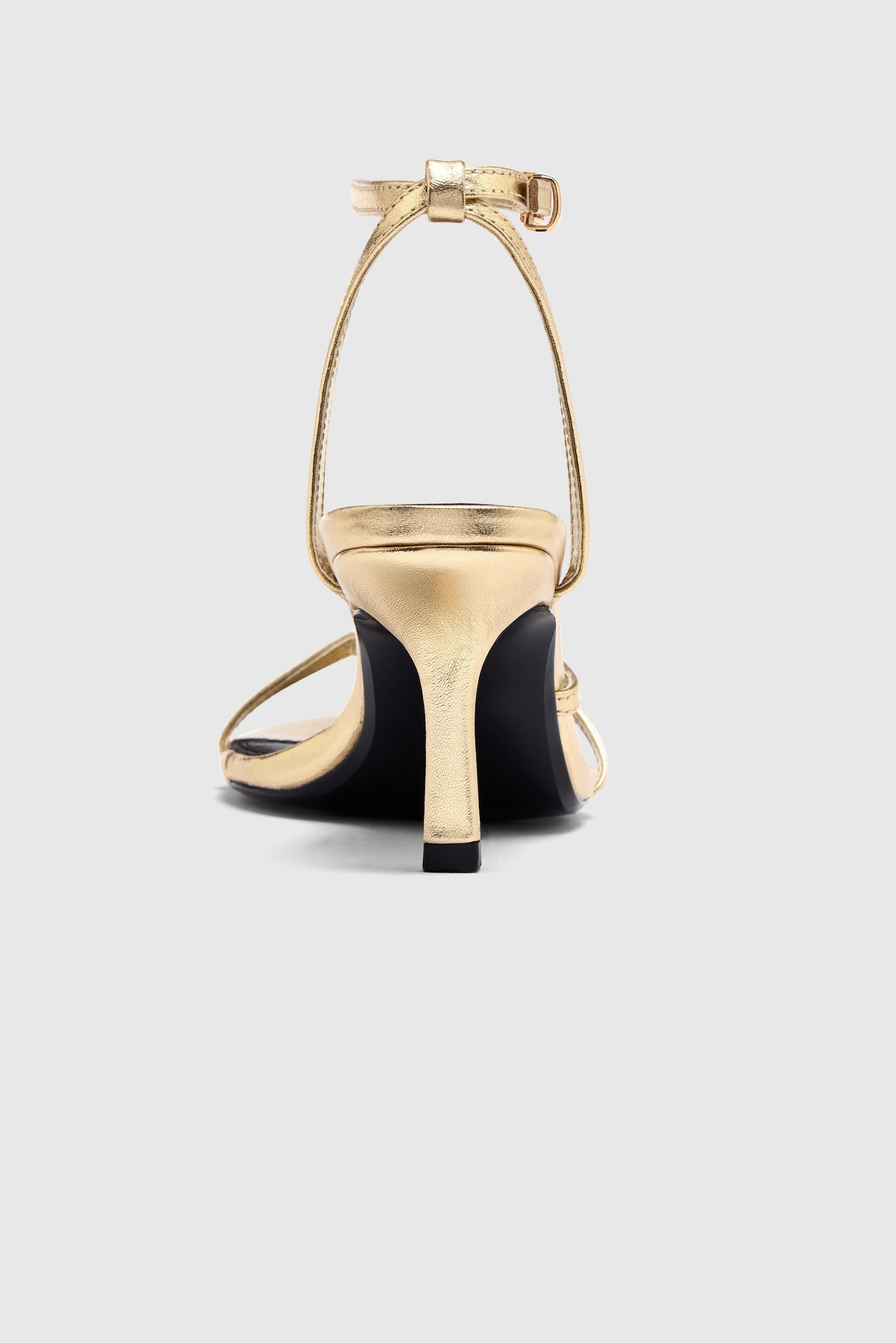 Gold leather asymmetric heeled sandals with an ankle strap