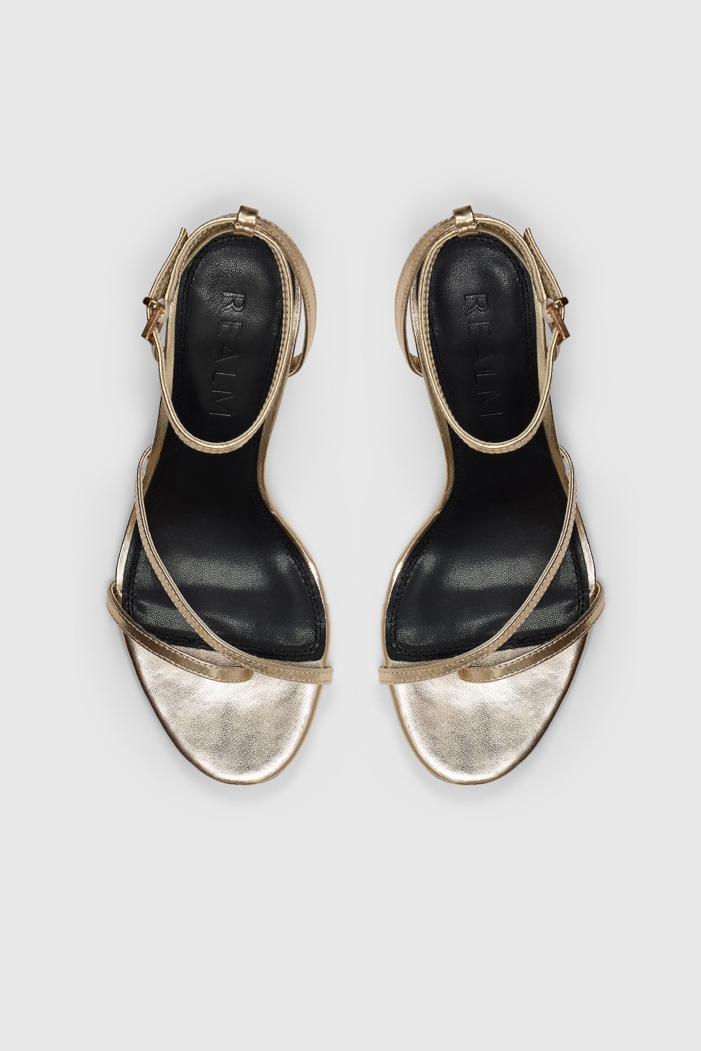 Gold leather asymmetric heeled sandals with an ankle strap