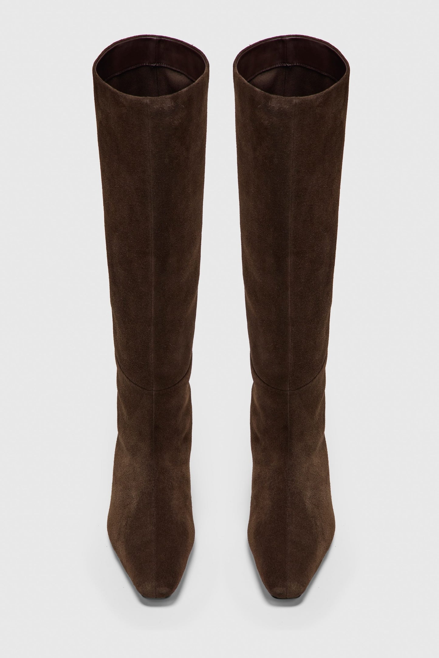 Pair of brown suede knee-high boots on a white background