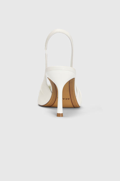 The Cascade Slingbacks by Realm in ivory leather are shown from the rear, featuring a slim, comfortable heel and brown leather sole with partial branding, set against a plain light gray background.