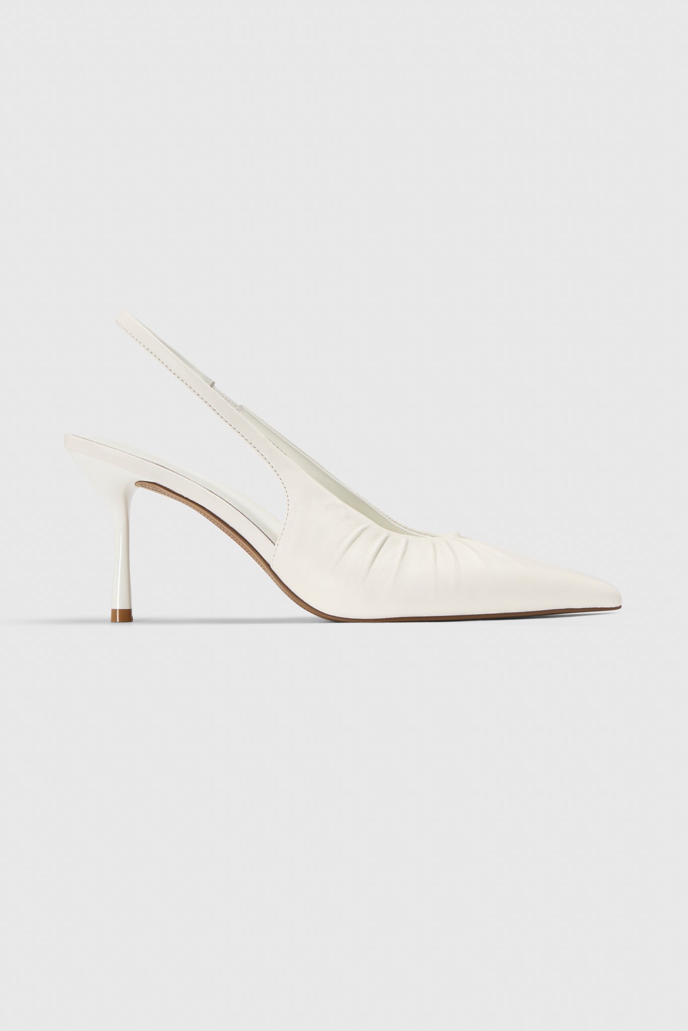 The Realm Cascade Slingbacks in white leather feature a gathered side detail and slim stiletto heel, shown against a plain light gray background.