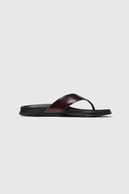 These flats feature a wide black leather strap and contoured footbed for everyday comfort. Displayed on a plain white background.