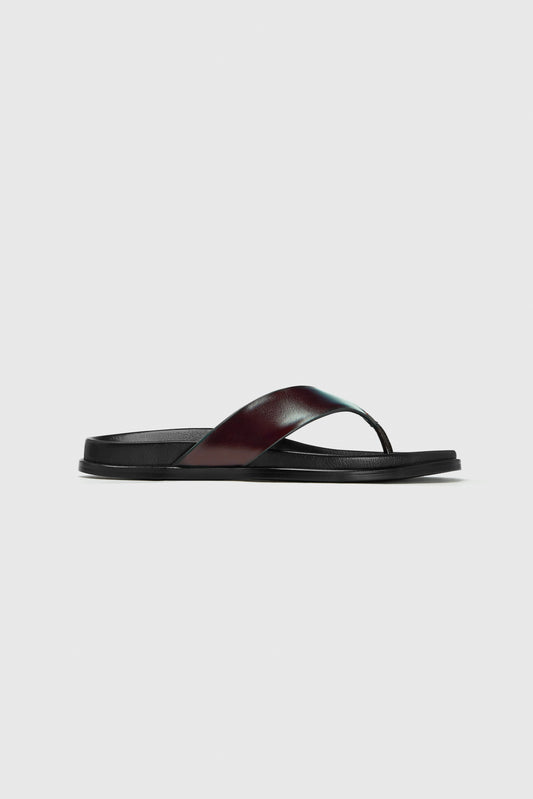 These flats feature a wide black leather strap and contoured footbed for everyday comfort. Displayed on a plain white background.