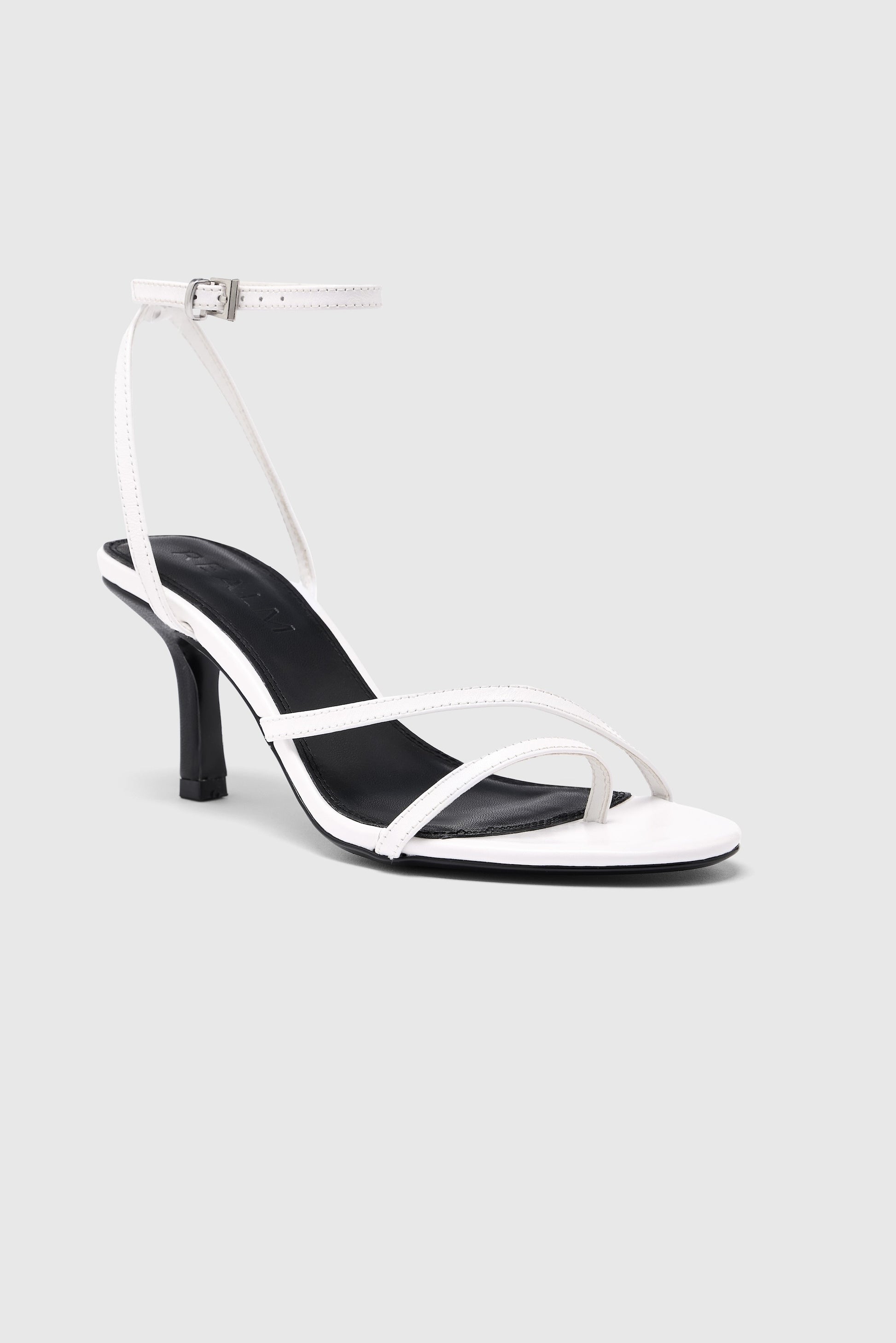 White leather asymmetric heeled sandals with an ankle strap