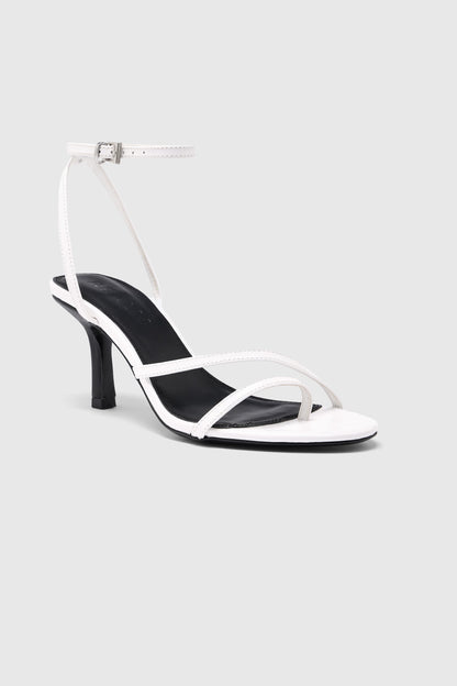 White leather asymmetric heeled sandals with an ankle strap