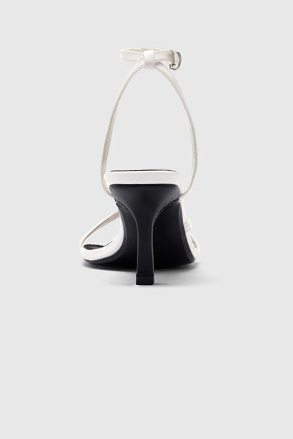 White leather asymmetric heeled sandals with an ankle strap