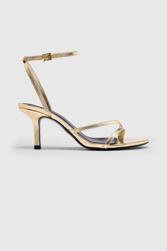 Gold leather asymmetric heeled sandals with an ankle strap