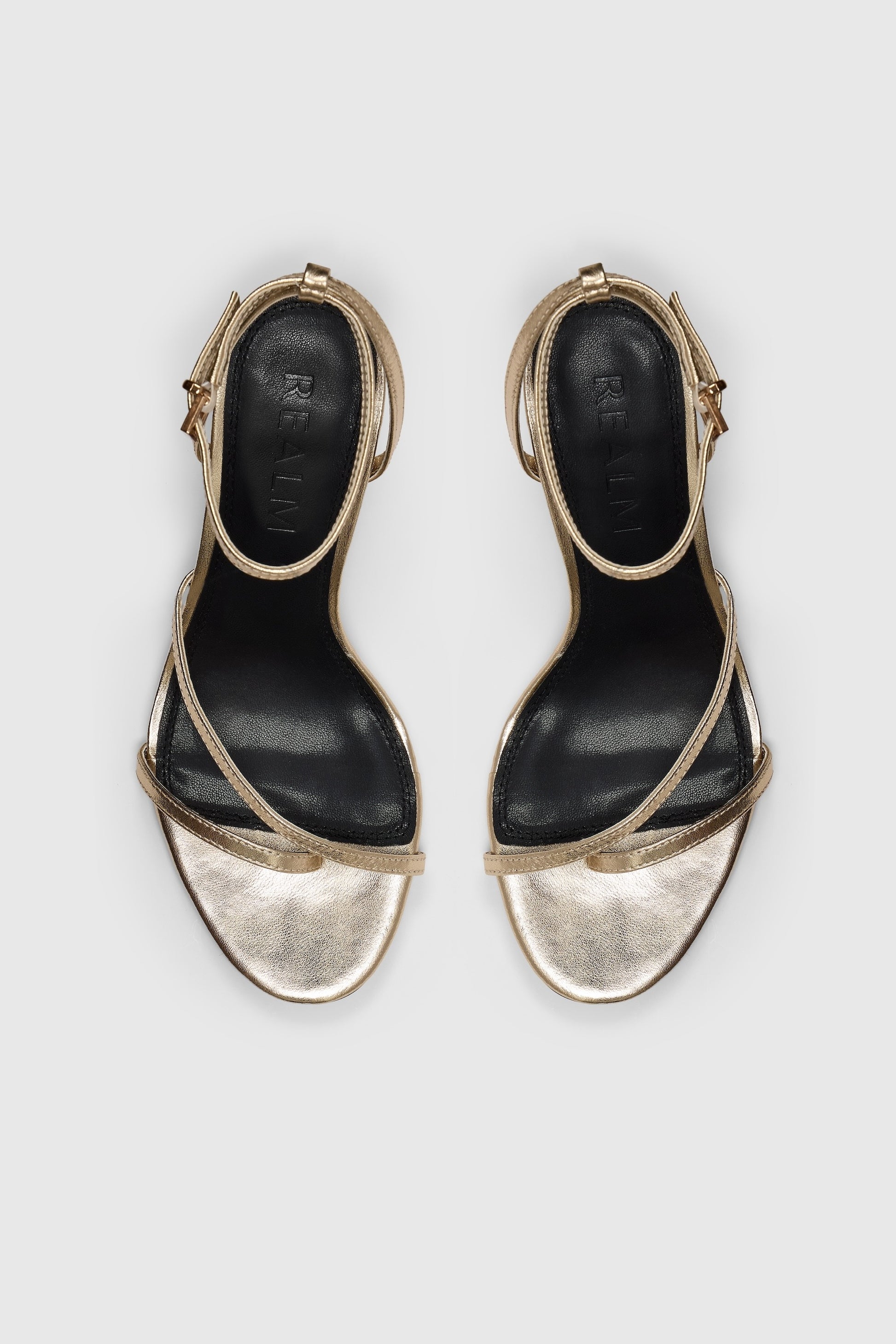 Gold leather asymmetric heeled sandals with an ankle strap
