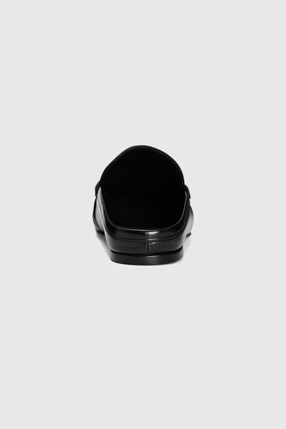 The Realm Everyday Loafers in black leather are slip-on shoes, shown from the back against a plain light gray background.