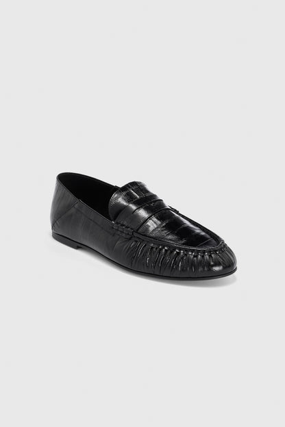 A pair of Realm Form Loafers | Gloss Black Leather in black embossed leather, featuring a moccasin-style toe, penny loafer strap, and subtle stitching details, displayed on a light gray background.