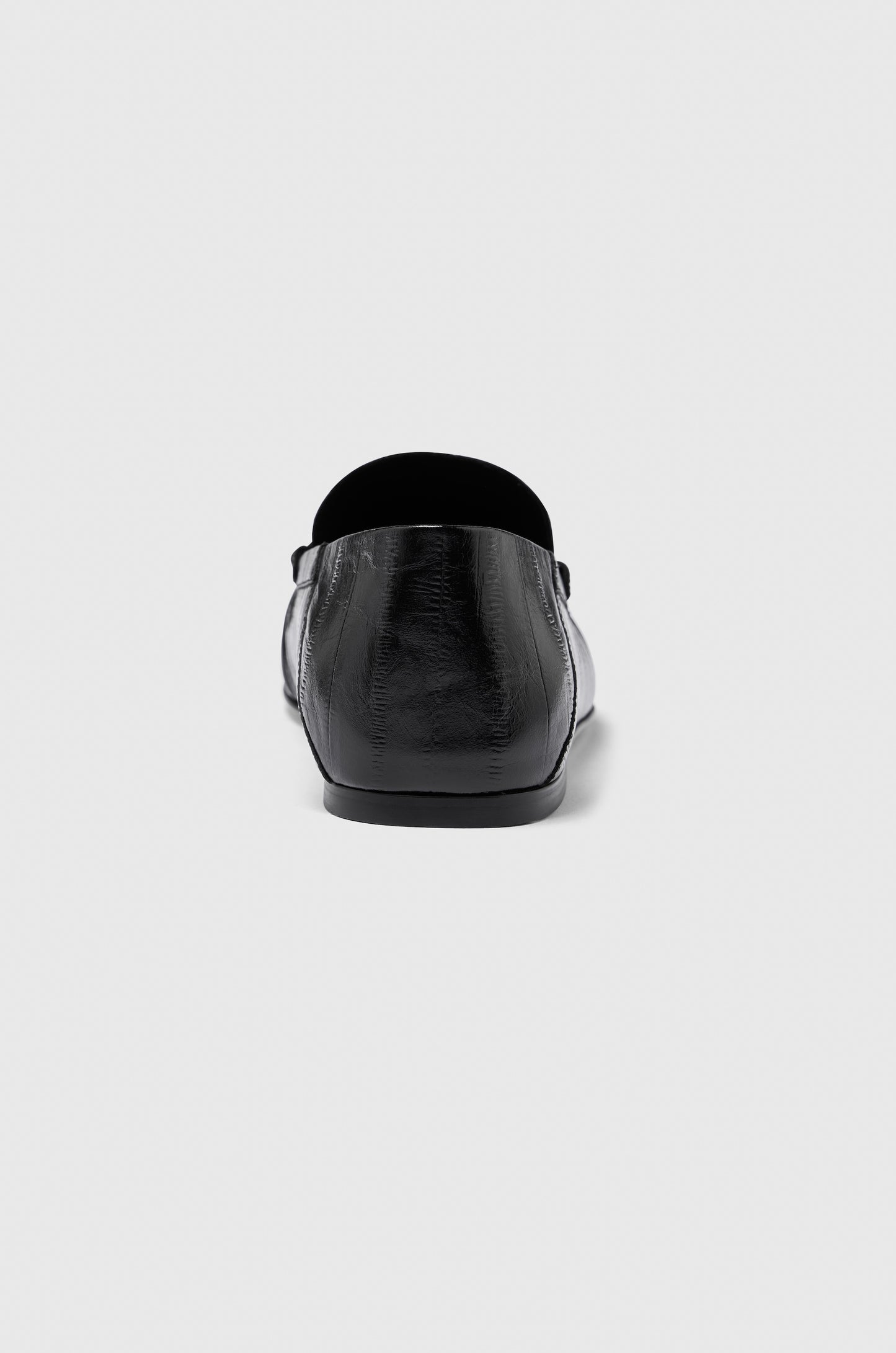 A single Realm Form Loafer in black leather is shown from the back against a plain light gray background.