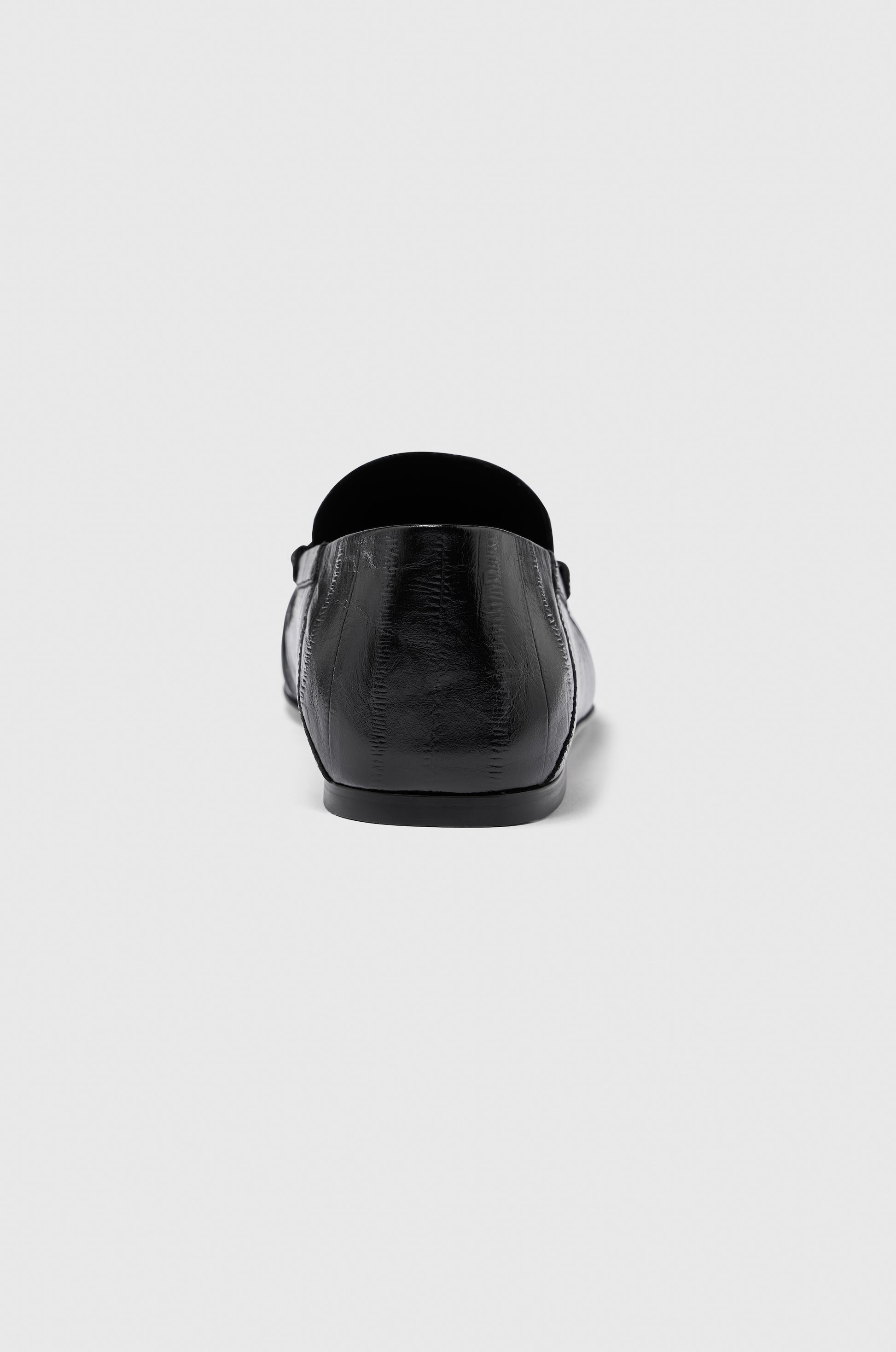 A single Realm Form Loafer in black leather is shown from the back against a plain light gray background.