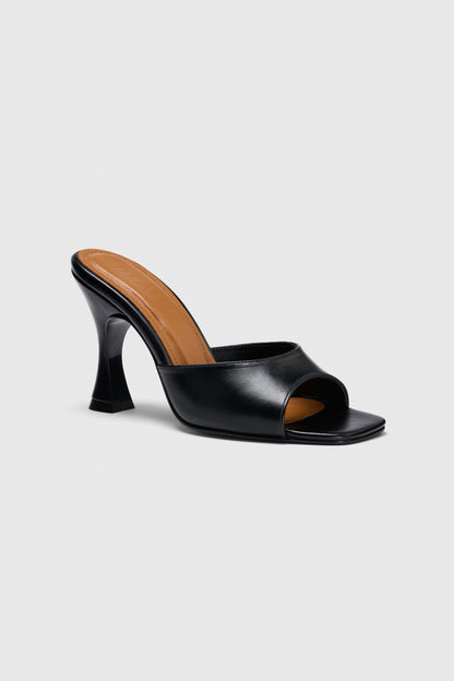 The mules are black leather open-toe heeled mules with a curved high heel and tan insole, shown on a light gray background.