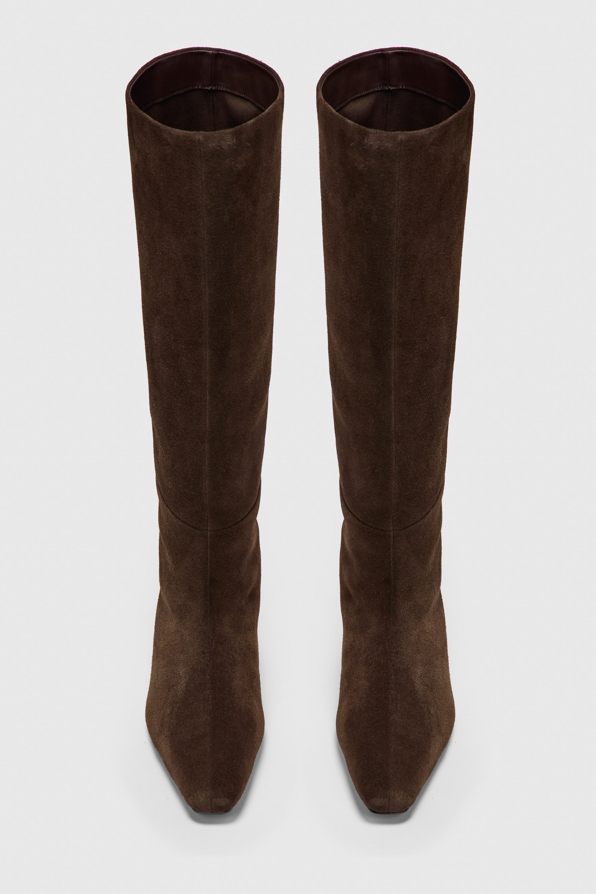 Pair of brown suede knee-high boots on a white background